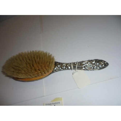 81 - A silver backed hair brush (some minor dents).