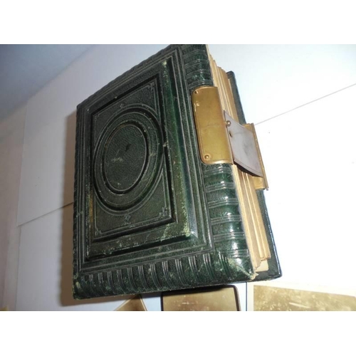 84 - A small Victorian photo album (spine needs repair) and loose photographs.