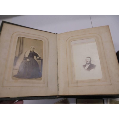 84 - A small Victorian photo album (spine needs repair) and loose photographs.