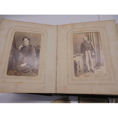 84 - A small Victorian photo album (spine needs repair) and loose photographs.