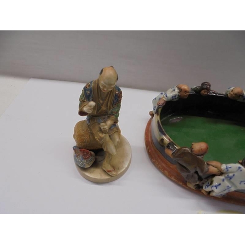 99 - A Japanese hand formed clay bowl with figures and two other figures (one a/f).