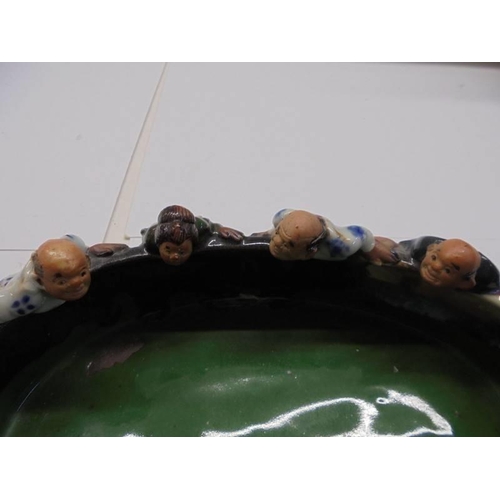 99 - A Japanese hand formed clay bowl with figures and two other figures (one a/f).