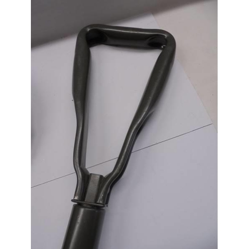 127 - A cased folding trench shovel (unused).