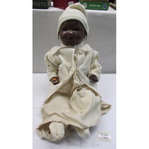 130 - A vintage British made black baby doll (hands a/f).