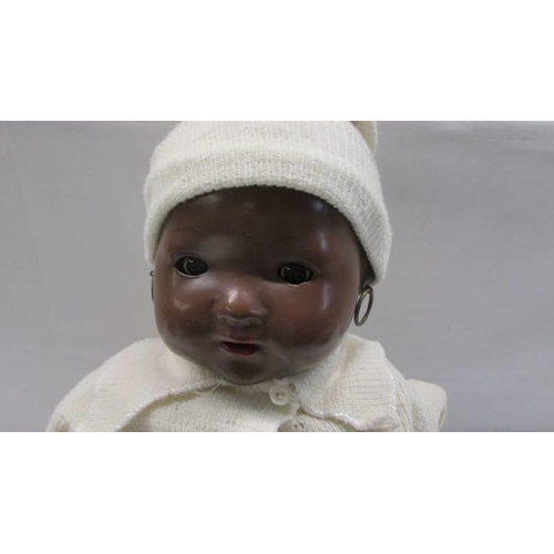 130 - A vintage British made black baby doll (hands a/f).