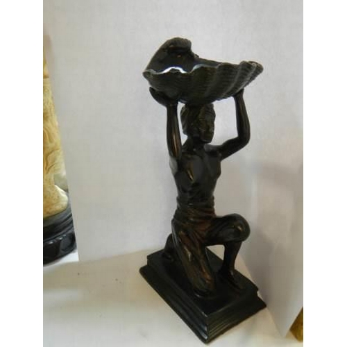 345 - An early 20th century bronze figure of a man holding a shell.