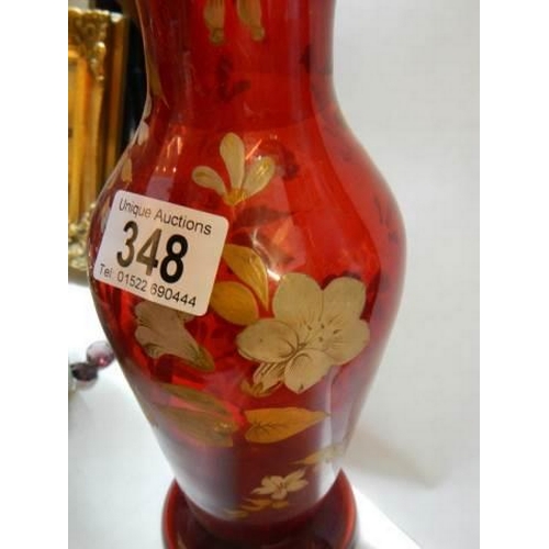 348 - A red glass hand painted vase with frilled rim.