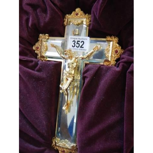 352 - A boxed bevelled glass and gilt Crucifix.