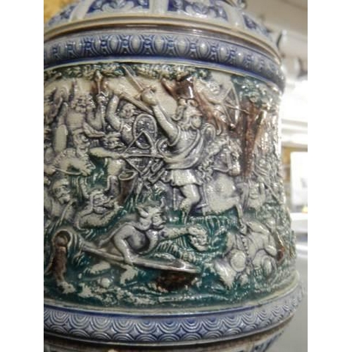 356 - A 20th century ceramic jug featuring battle scenes.