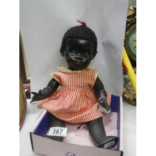 367 - A vintage black baby doll.