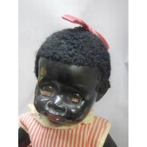 367 - A vintage black baby doll.