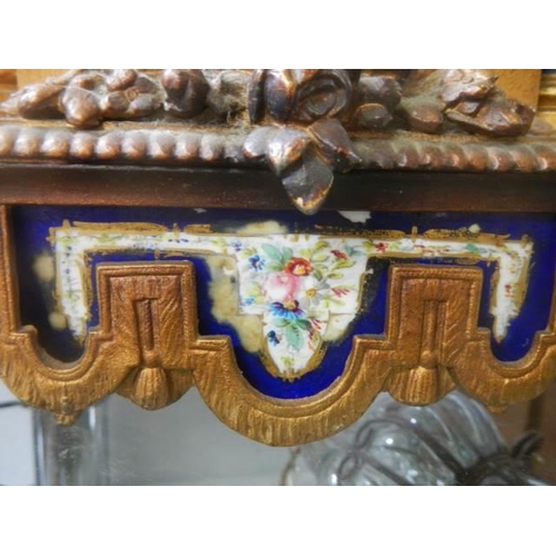 378 - A late Victorian mantle clock with painted panels, in working order but missing hands.