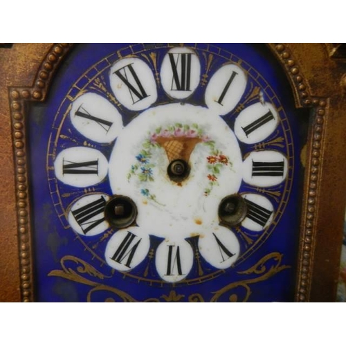 378 - A late Victorian mantle clock with painted panels, in working order but missing hands.