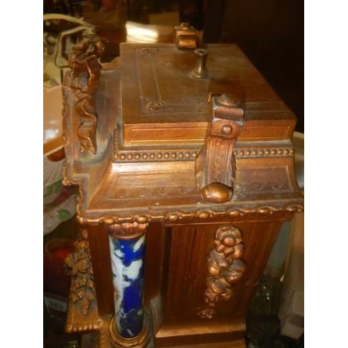 378 - A late Victorian mantle clock with painted panels, in working order but missing hands.