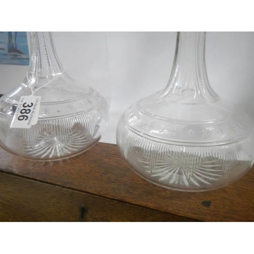 386 - A pair of early 20th century glass decanters, one stopper chipped.