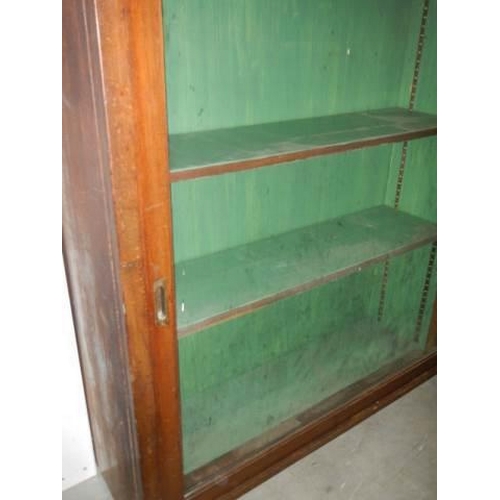 495 - A good glazed sliding door book case, COLLECT ONLY.