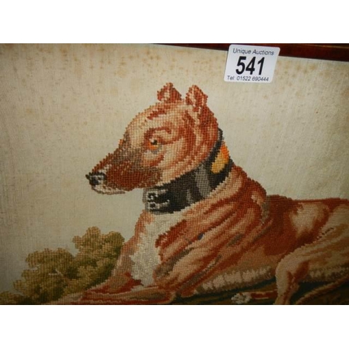 541 - An early 20th century mahogany framed tapestry of a dog.