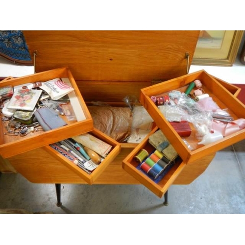 545 - A good quality retro style sewing box with inner shelves complete with contents. COLLECT ONLY.