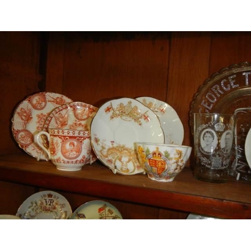 562 - A mixed lot of commemorative ware on two shelves. COLLECT ONLY.