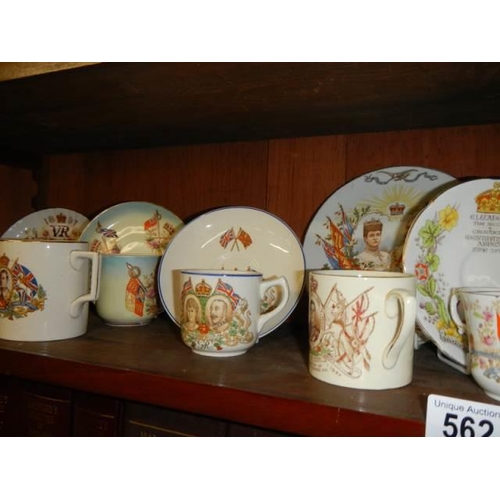 562 - A mixed lot of commemorative ware on two shelves. COLLECT ONLY.