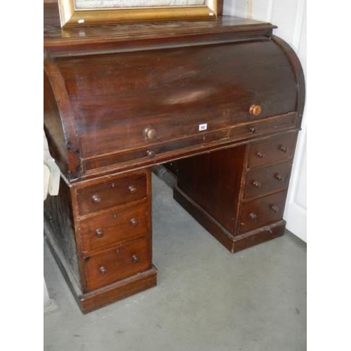 582 - A late Victorian double pedestal dome top desk with pull-out slide. COLLECT ONLY.