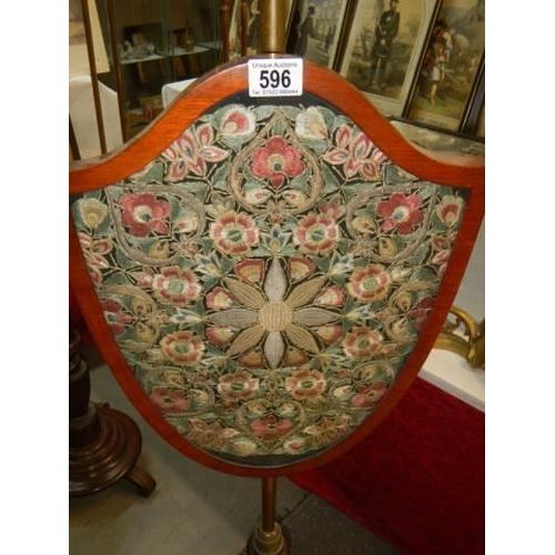 596 - A Victorian mahogany adjustable pole screen with shield shaped panel. COLLECT ONLY.