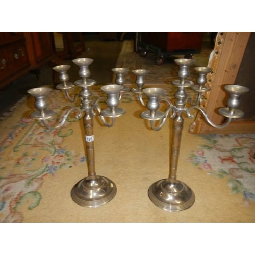 628 - A pair of plated five branch candelabra.