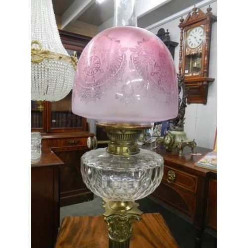 648 - A brass Corinthian column oil lamp with original shade. COLLECT ONLY.