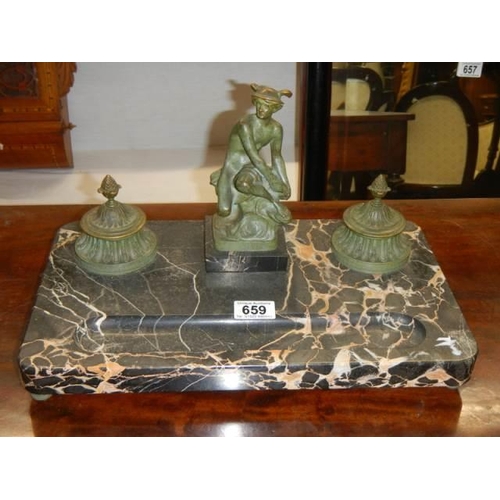 659 - A Victorian bronze inkwell featuring a figure on a slate base. COLLECT ONLY.