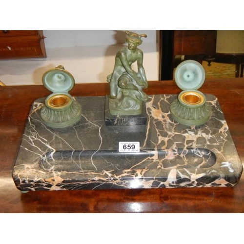 659 - A Victorian bronze inkwell featuring a figure on a slate base. COLLECT ONLY.