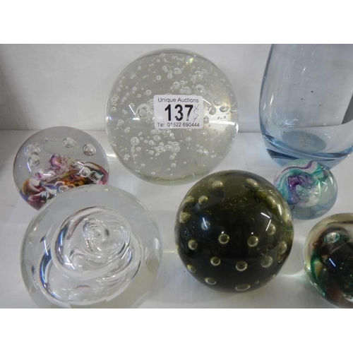 137 - A collection of glass paperweights and a heavy glass vase.