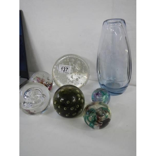 137 - A collection of glass paperweights and a heavy glass vase.