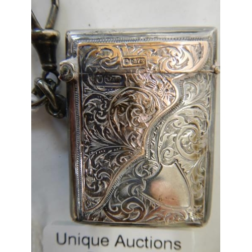 169 - A hall marked silver vesta case with gold (375) mounts, in good condition.