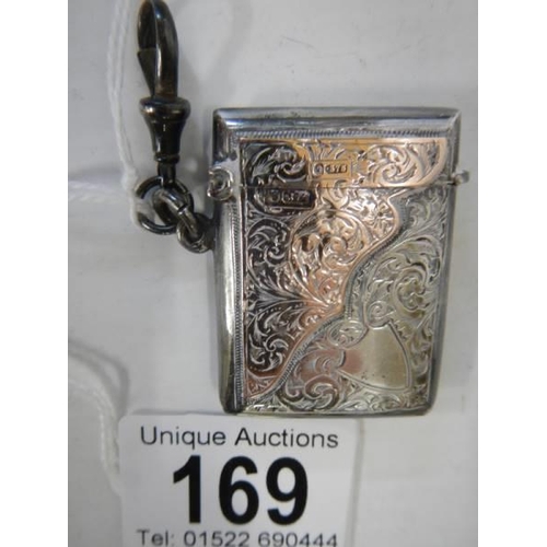 169 - A hall marked silver vesta case with gold (375) mounts, in good condition.