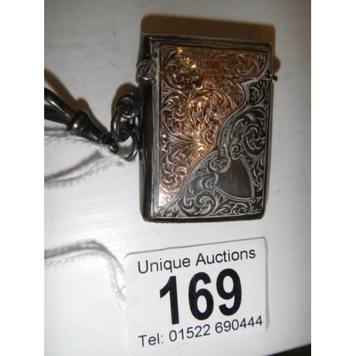 169 - A hall marked silver vesta case with gold (375) mounts, in good condition.