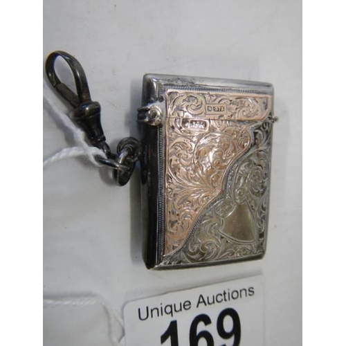 169 - A hall marked silver vesta case with gold (375) mounts, in good condition.