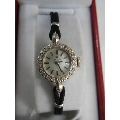 193 - A ladies Omega wristwatch encrusted with diamond chips, in working order.