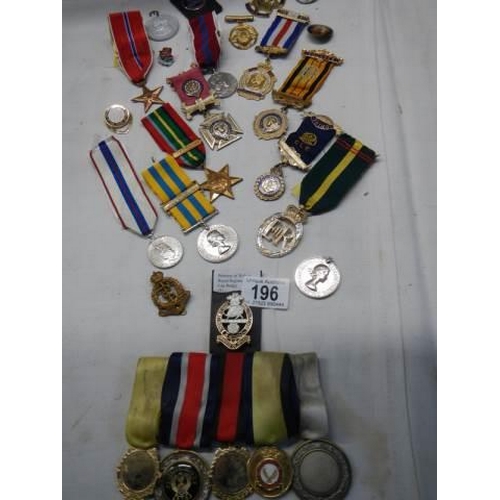 196 - A mixed lot of 20th century medals etc.,