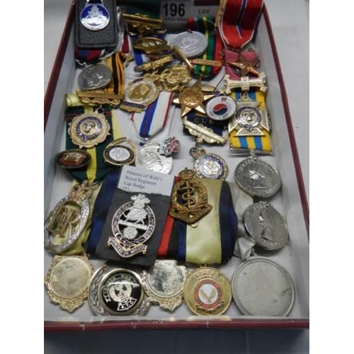 196 - A mixed lot of 20th century medals etc.,