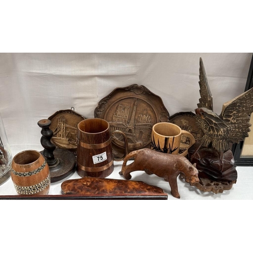 75 - A quantity of wooden carved items including Plaques, eagle, cat candlestick holder etc