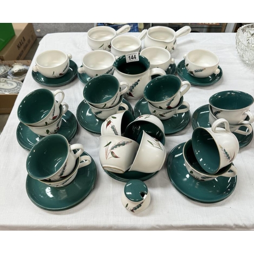 144 - A quantity of Denby 'GreenWheat' cups & saucers, soup bowls etc