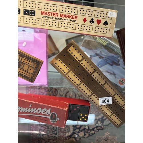 404 - A quantity of cribbage boards, dominoes & playing cards