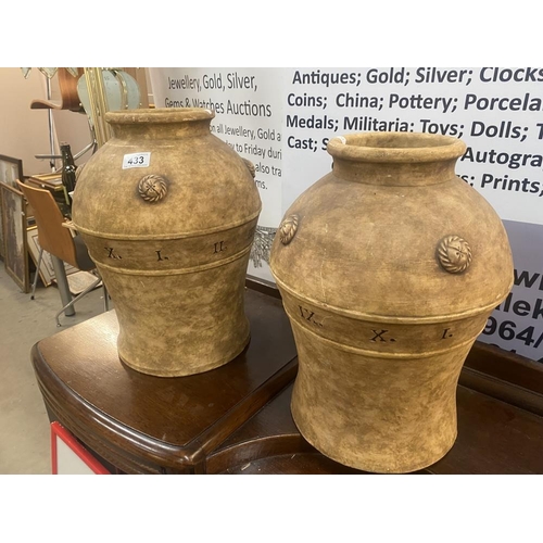 433 - A pair of large unusual ceramic vases featuring Roman numerals