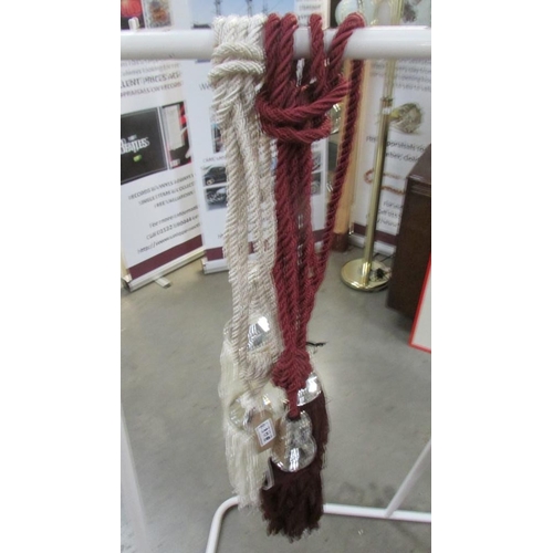 430B - A pair of red wine curtain tie backs with ribbon and gem effect embellishment and tassels and a pair... 