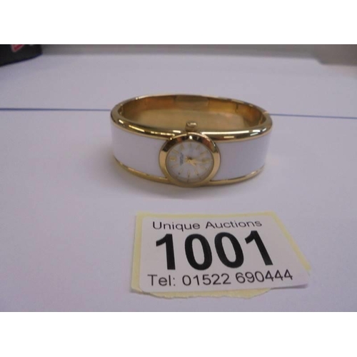 1001 - A Caravelle New York white enamel bangle watch, in working order.