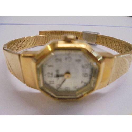 1002 - A Lorus ladies wrist watch on a yellow metal bracelet.