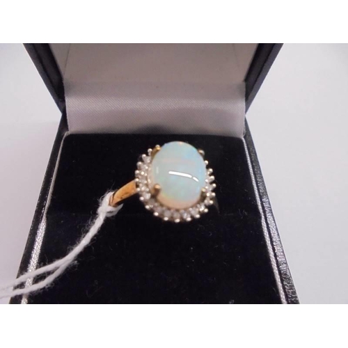 1010 - A 9ct gold ring set opal, size P, 2.56 grams.