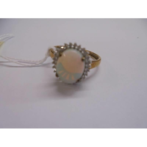 1010 - A 9ct gold ring set opal, size P, 2.56 grams.