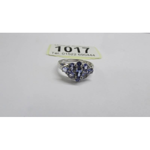 1017 - A white gold tanzanite and diamond cluster ring, size P half, 2.8 grams.