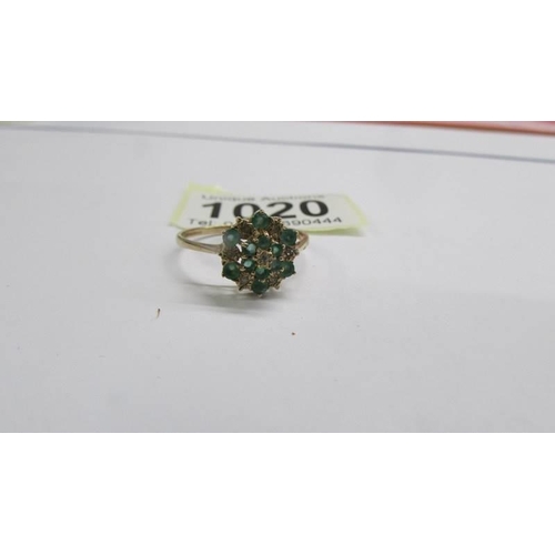 1020 - A 9ct yellow gold diamond and emerald cluster ring, size W. 2.46 grams.